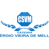 banner_notícia_cátedra
#ParaTodosVerem:
Imagem com fundo claro e elementos gráficos em tons de azul. Ao centro, há um símbolo em formato octogonal com a sigla “CSVM”. Abaixo, aparece a palavra “Cátedra” e, em destaque, o nome “Sérgio Vieira de Mello”. O símbolo é acompanhado por ramos estilizados nas laterais, formando uma composição simétrica. Trata-se da identidade visual da Cátedra Sérgio Vieira de Mello.